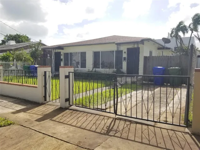 a view of a house with a wooden deck and a floor to ceiling window