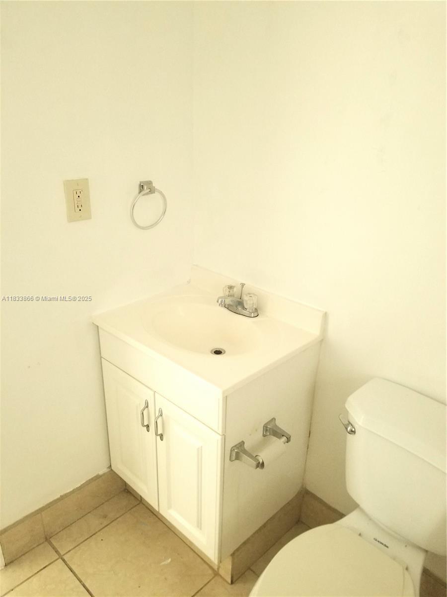 1240 Southwest 22nd Terrace, Unit 1 Miami, FL 33145 - Photo 11 of 14 a bathroom with a sink and mirror with toilet