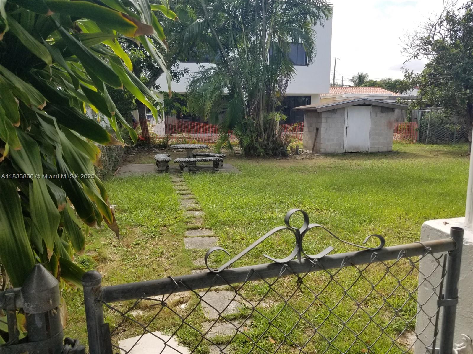 1240 Southwest 22nd Terrace, Unit 1 Miami, FL 33145 - Photo 13 of 14 a view of a garden with a bench