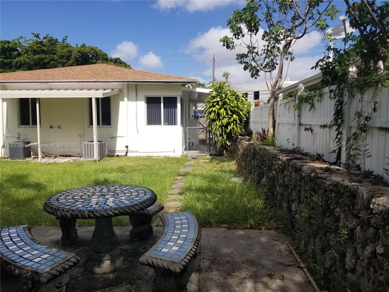 1240 Southwest 22nd Terrace, Unit 1 Miami, FL 33145 - Photo 14 of 14 a view of a house with backyard and sitting area