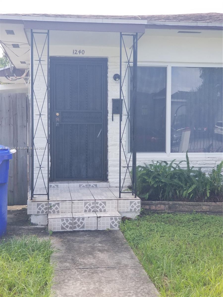 1240 Southwest 22nd Terrace, Unit 1 Miami, FL 33145 - Photo 2 of 14 a view of a house with a yard