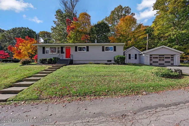a front view of a house with a garden and yard