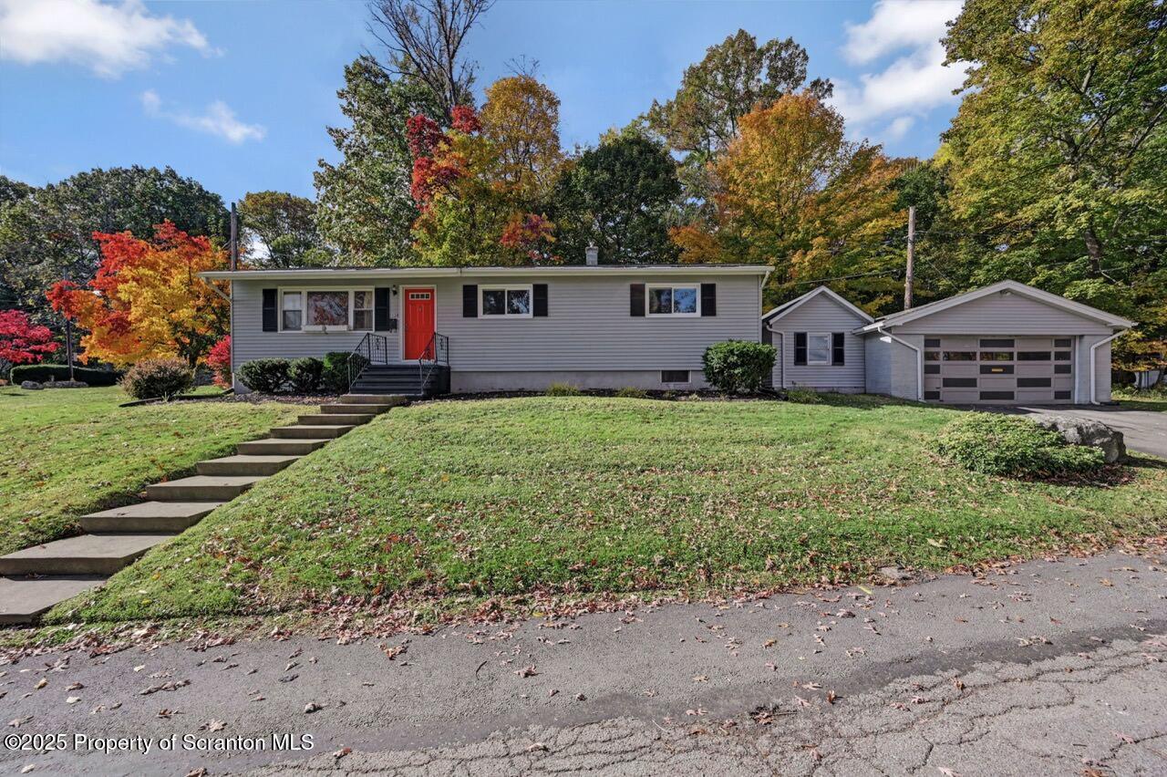 a front view of a house with a garden and yard