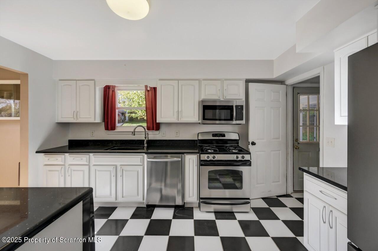 524 Knapp Road Clarks Summit, PA 18411 - Photo 17 of 45 a kitchen with granite countertop a sink and a stove