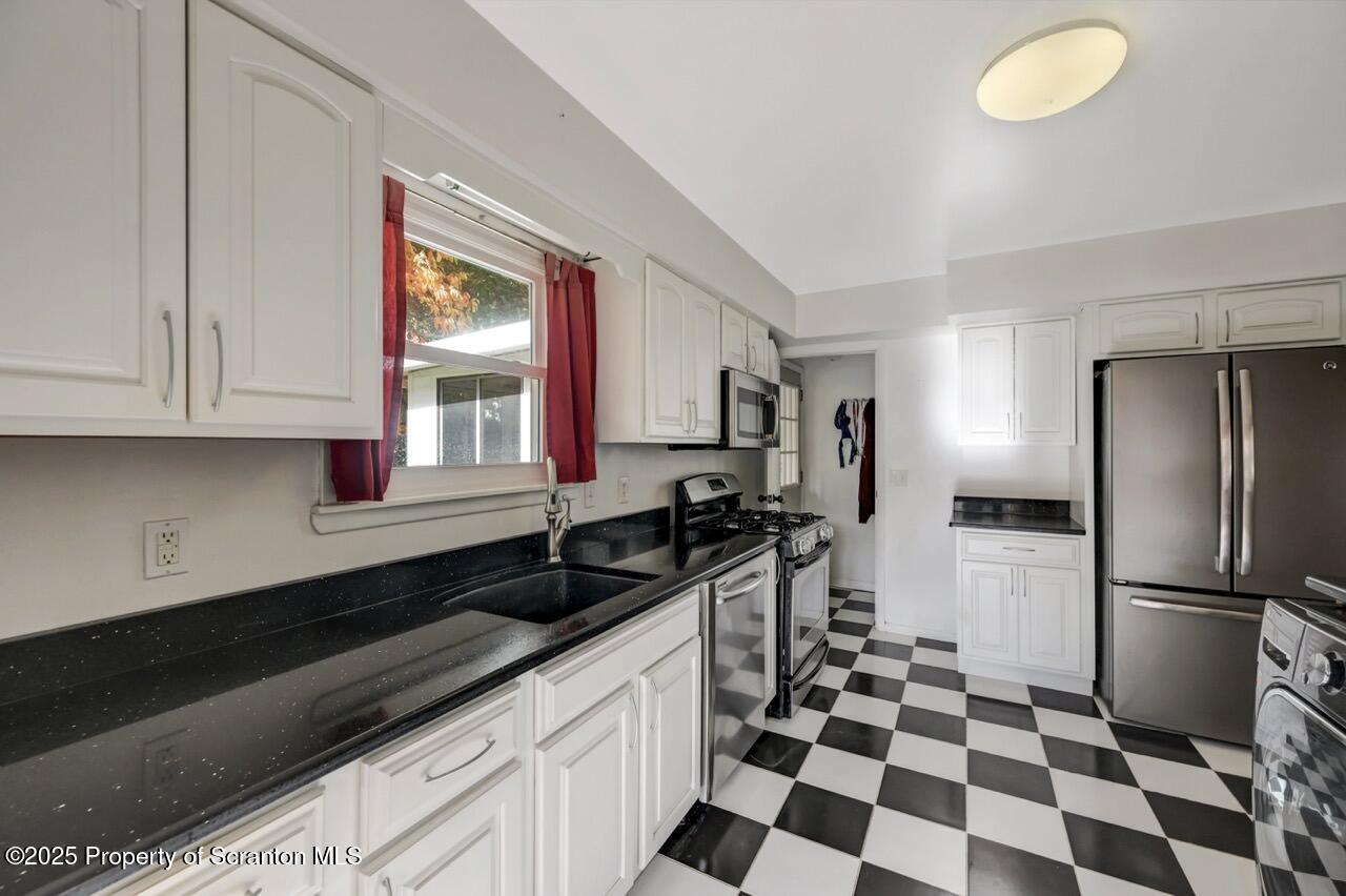 524 Knapp Road Clarks Summit, PA 18411 - Photo 18 of 45 a kitchen with a sink a refrigerator and cabinets