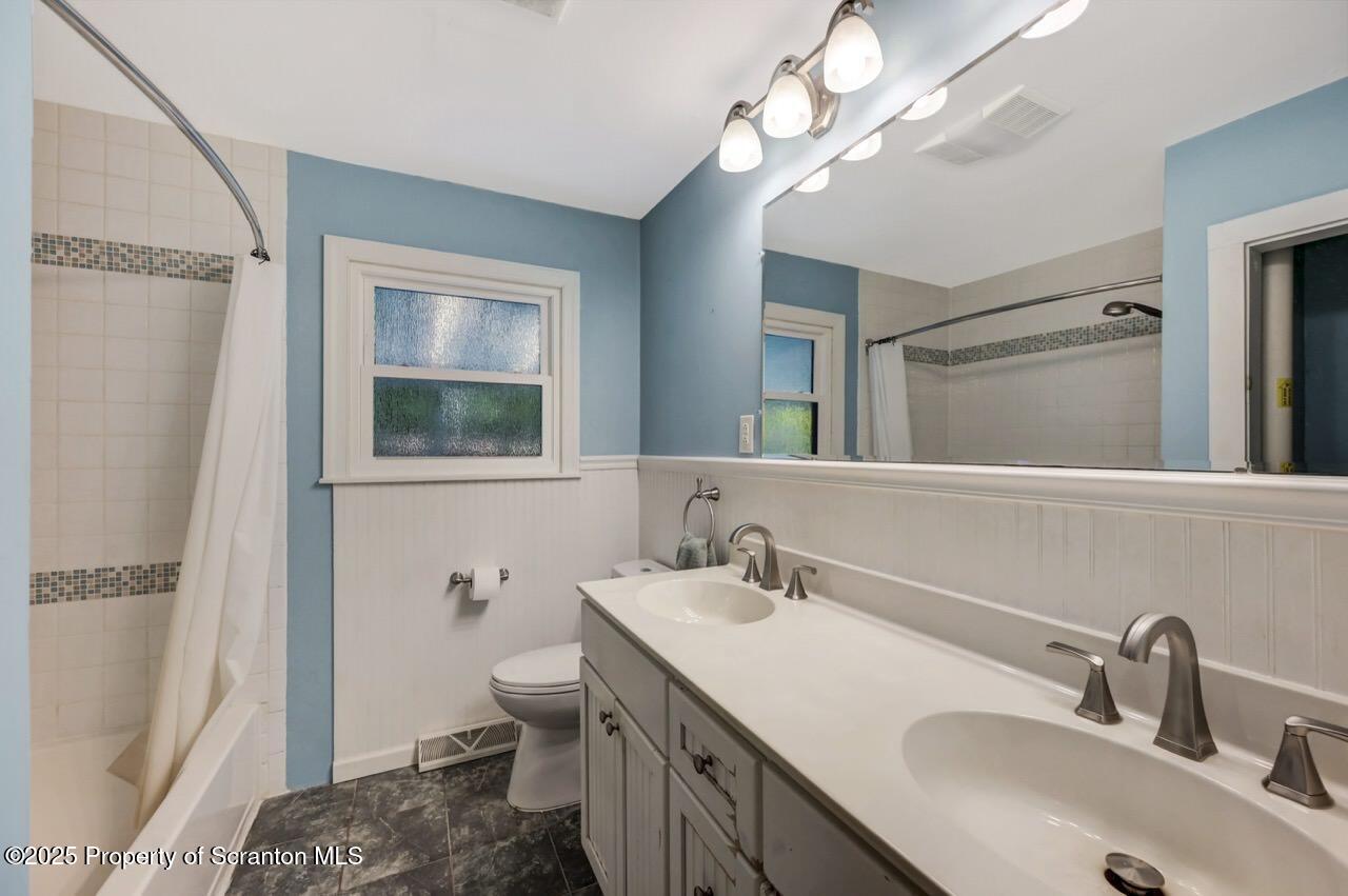 524 Knapp Road Clarks Summit, PA 18411 - Photo 21 of 45 a bathroom with a sink a toilet and a mirror