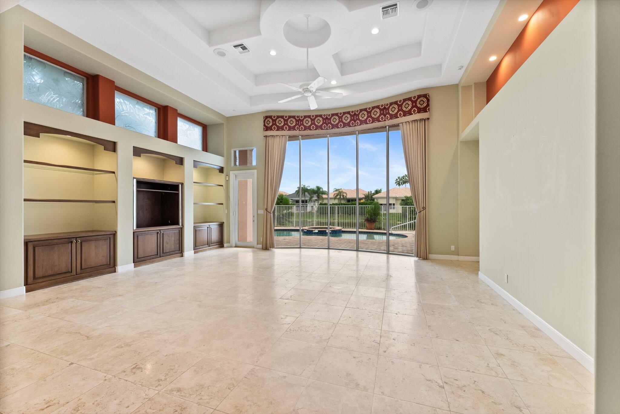 7081 Mallorca Crescent Boca Raton, FL 33433 - Photo 8 of 26 a view of an empty room with a fireplace and a window