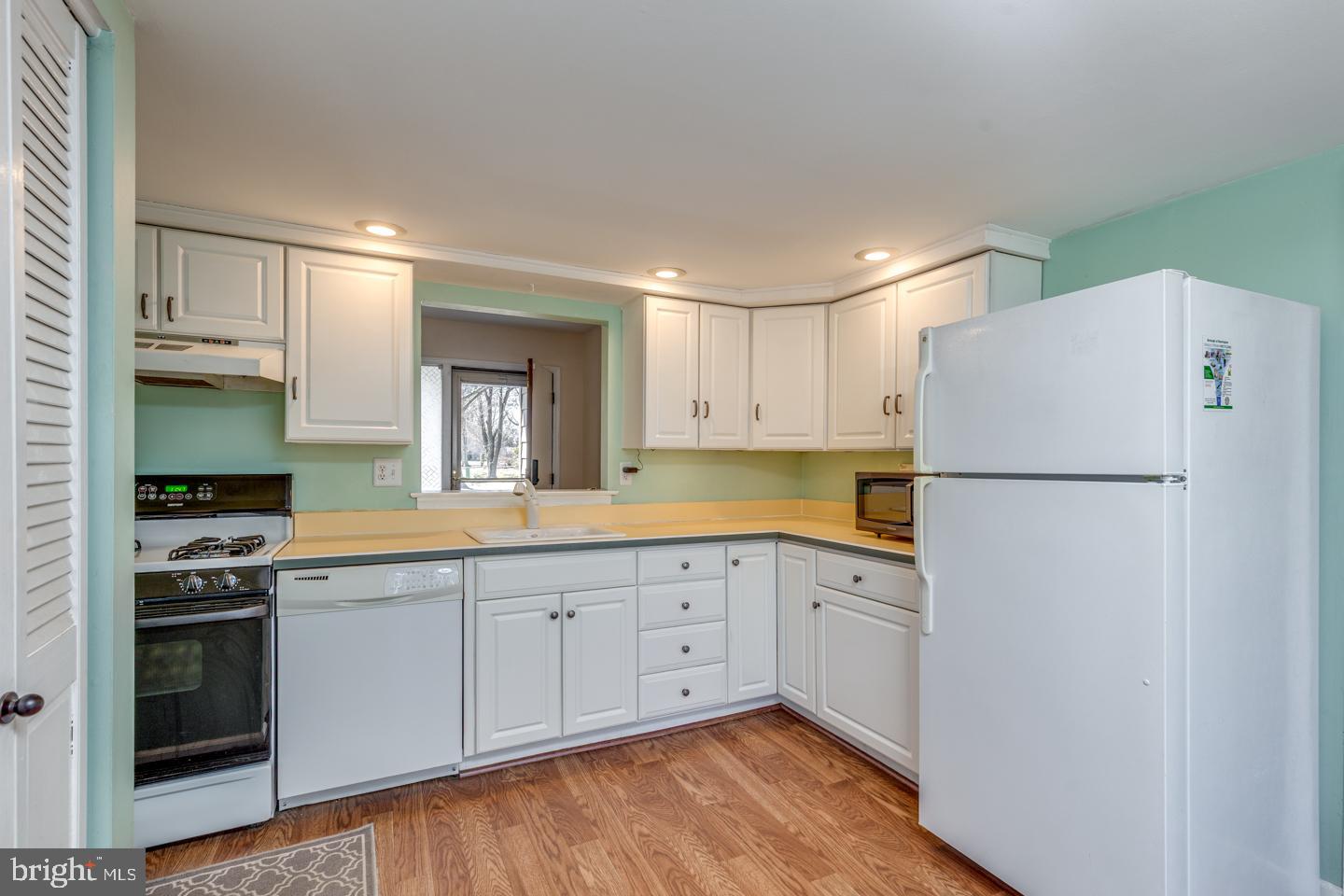 923 Chesterfield Road Haddonfield, NJ 08033 - Photo 12 of 31 a kitchen with white cabinets and white appliances