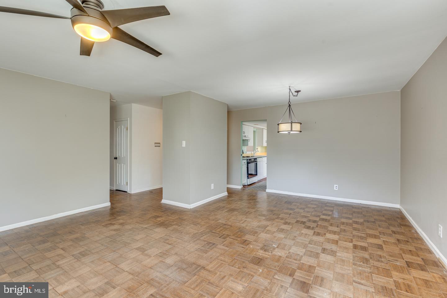 923 Chesterfield Road Haddonfield, NJ 08033 - Photo 9 of 31 an empty room with chandelier fan and windows