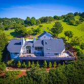 an aerial view of a house with garden space and street view