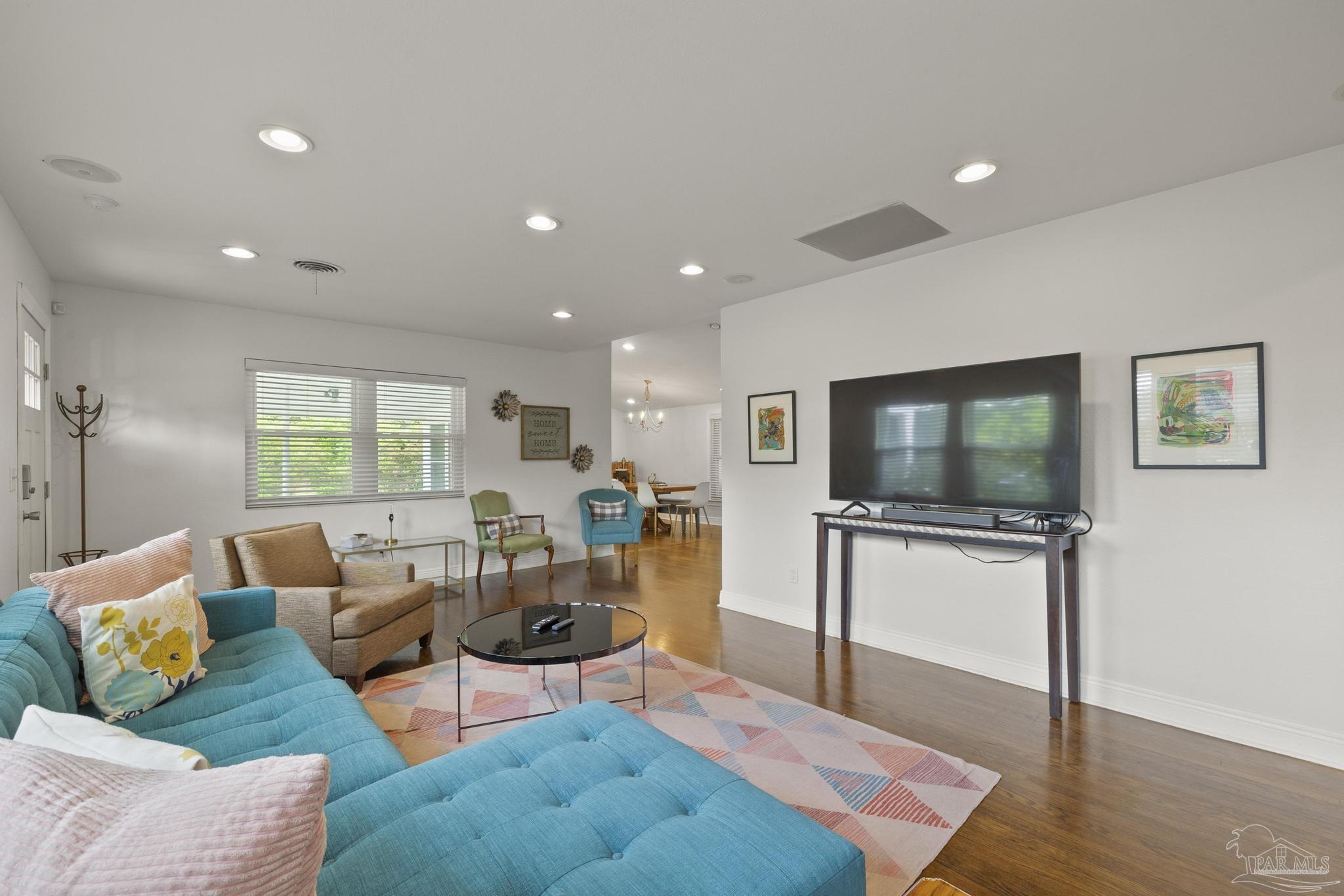 a living room with furniture and a flat screen tv