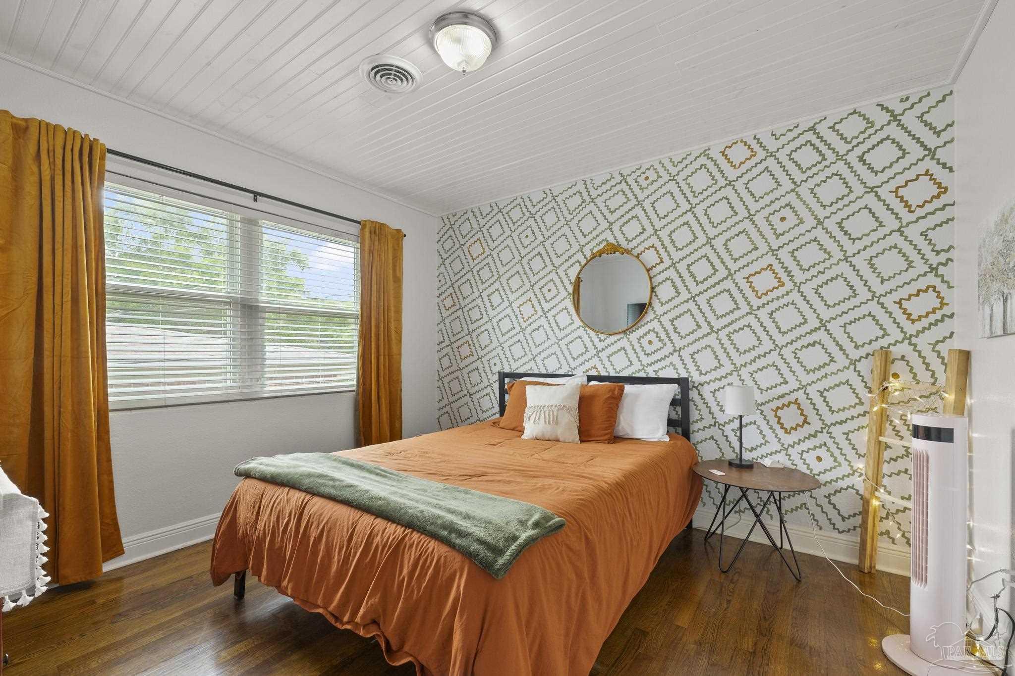 200 Clematis Street Pensacola, FL 32503 - Photo 16 of 33 a bedroom with a bed and a dresser next to a window