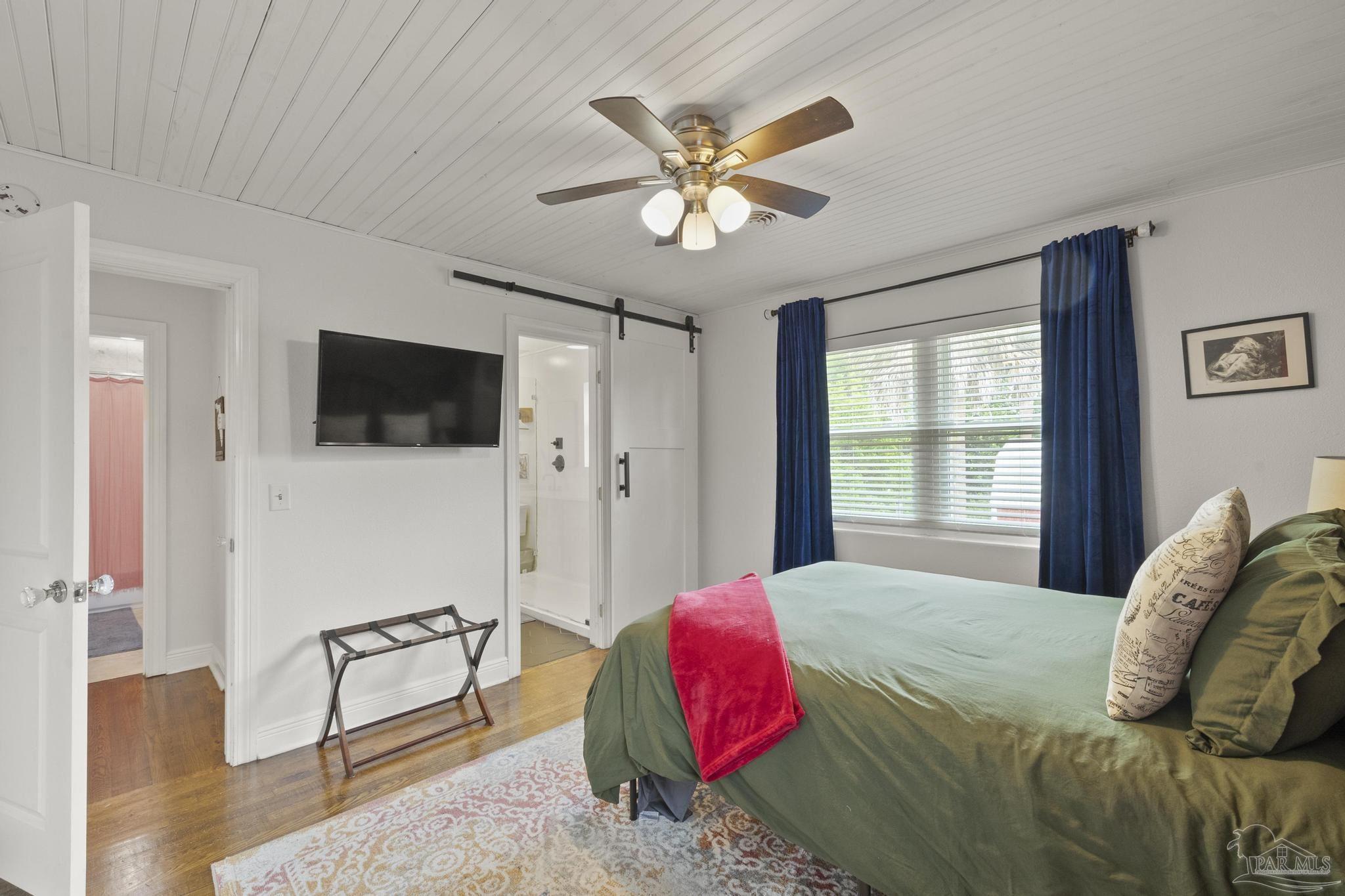 200 Clematis Street Pensacola, FL 32503 - Photo 19 of 33 a bedroom with a bed and a flat screen tv