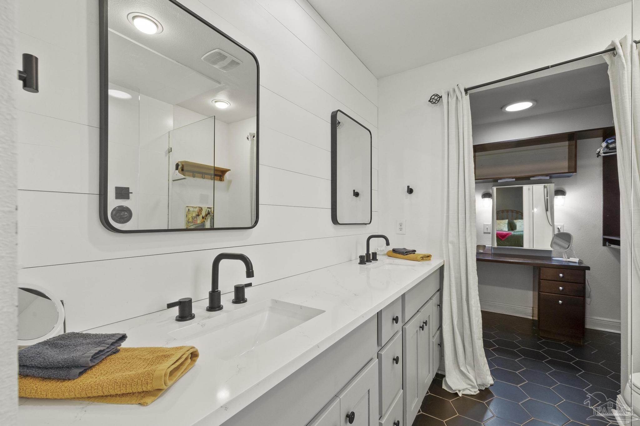 200 Clematis Street Pensacola, FL 32503 - Photo 20 of 33 a bathroom with a double vanity sink and a mirror