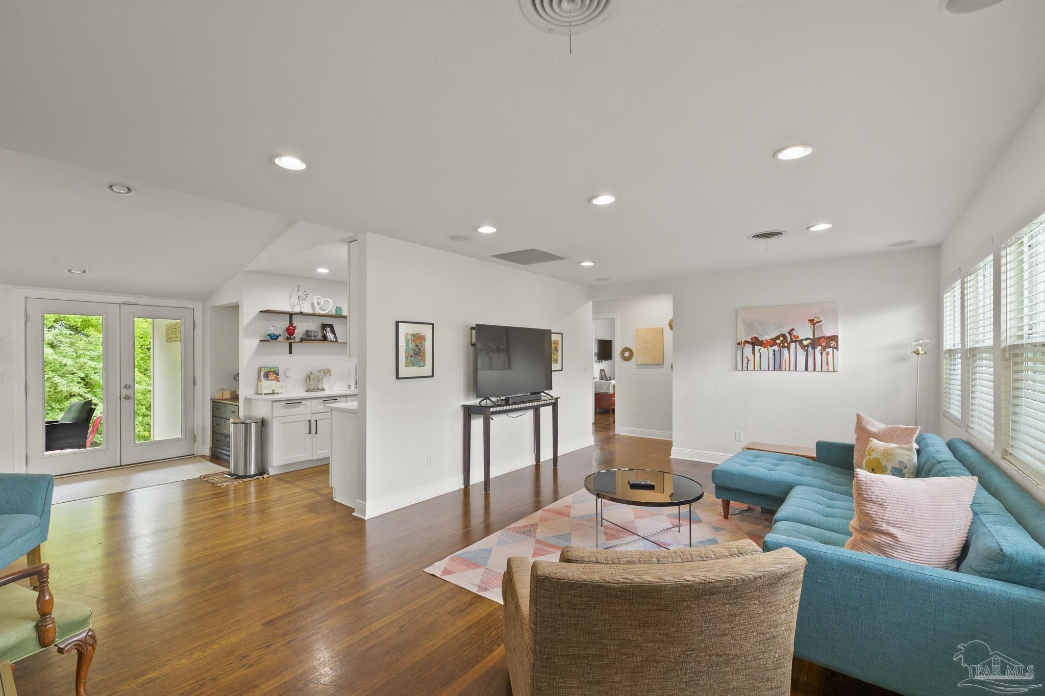 200 Clematis Street Pensacola, FL 32503 - Photo 2 of 33 a living room with fireplace furniture and a wooden floor