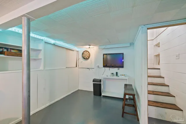 a view of a back yard with an tree and wooden fence