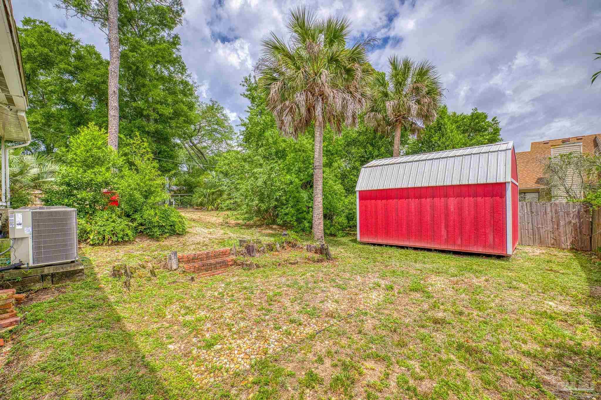 200 Clematis Street Pensacola, FL 32503 - Photo 27 of 33 a view of a back yard with an tree and wooden fence