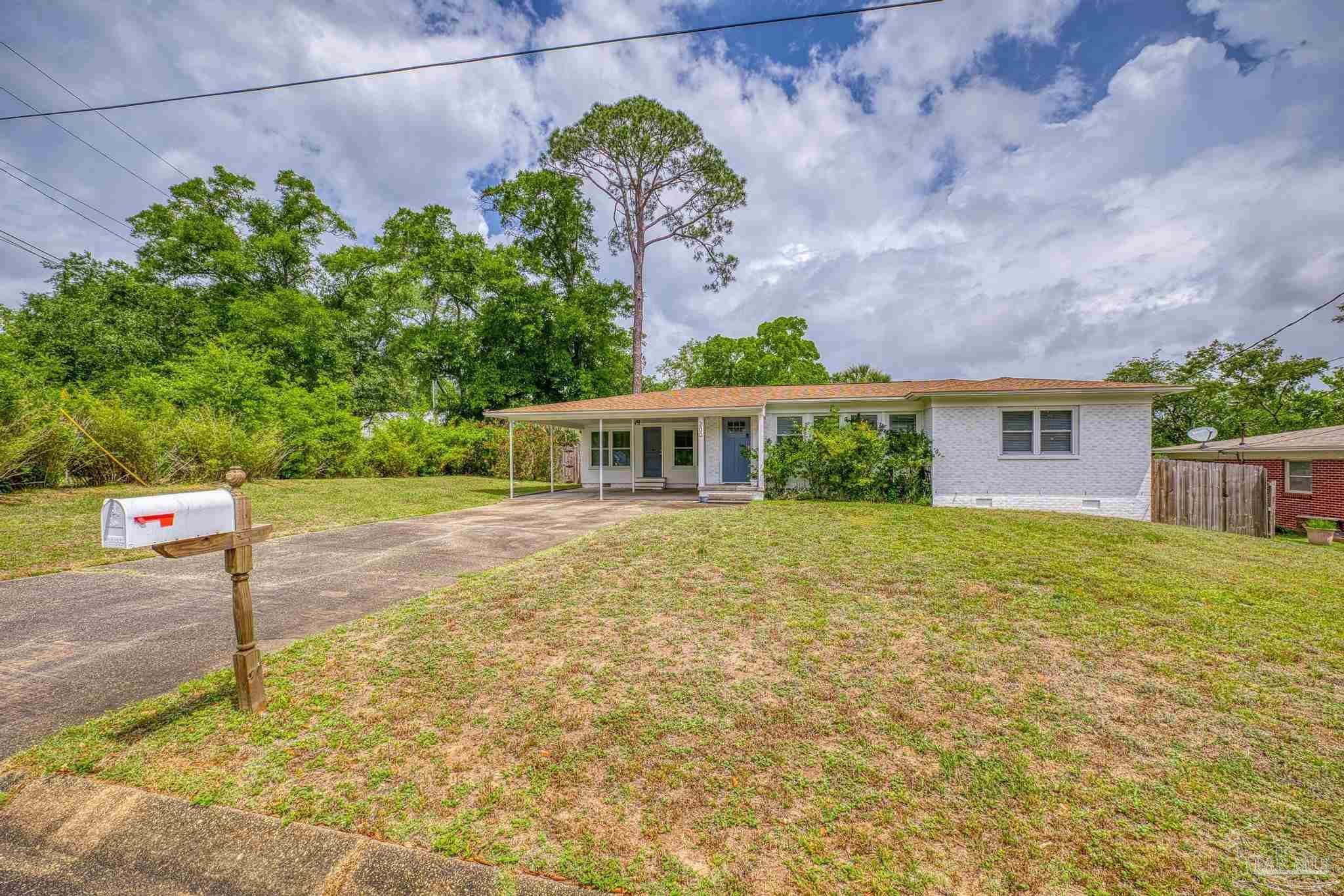 200 Clematis Street Pensacola, FL 32503 - Photo 31 of 33 a front view of a house with a yard and garage