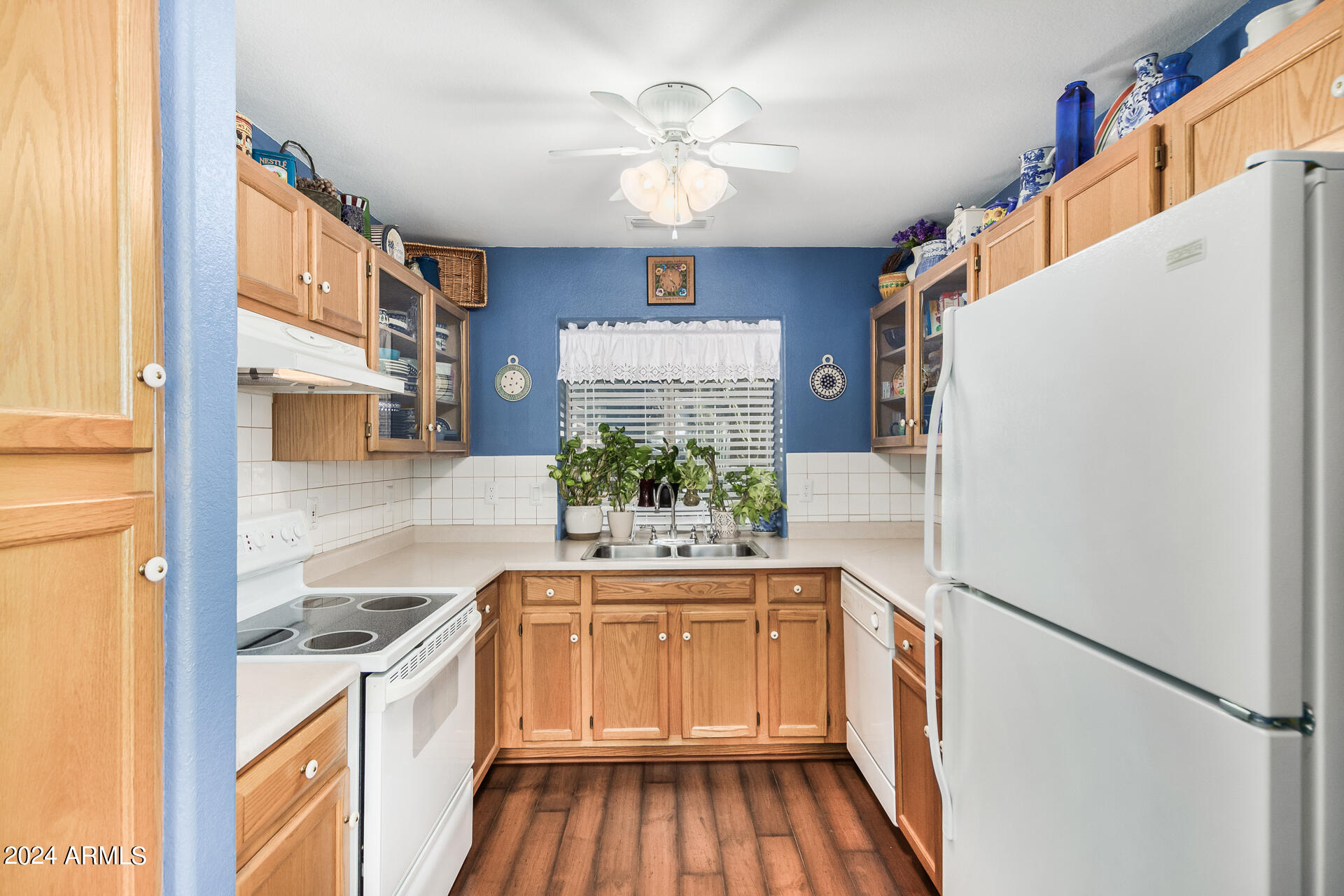 9124 West Calavar Road Peoria, AZ 85381 - Photo 13 of 25 a kitchen with a refrigerator and a sink