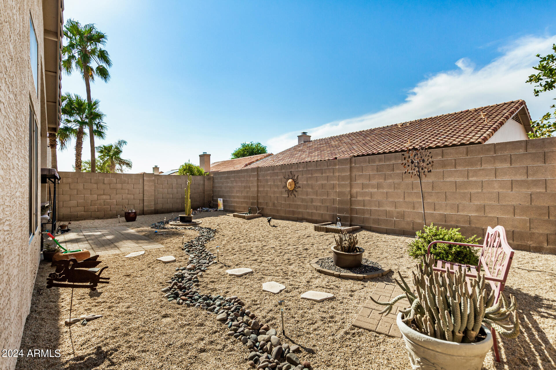 9124 West Calavar Road Peoria, AZ 85381 - Photo 22 of 25 a backyard of a house with table and chairs