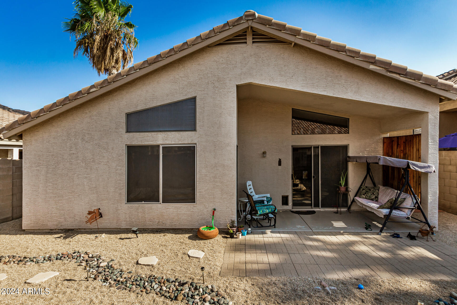 9124 West Calavar Road Peoria, AZ 85381 - Photo 23 of 25 a backyard of a house with seating space