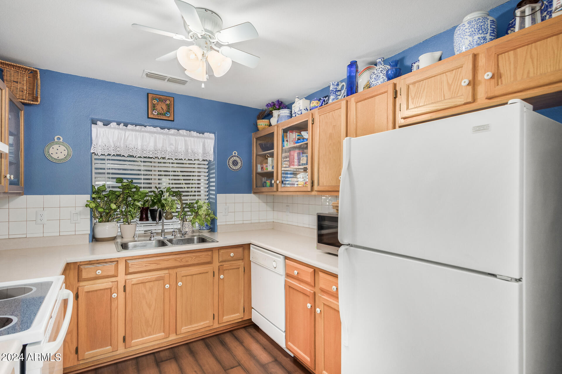 9124 West Calavar Road Peoria, AZ 85381 - Photo 3 of 25 a kitchen with stainless steel appliances a refrigerator sink and cabinets