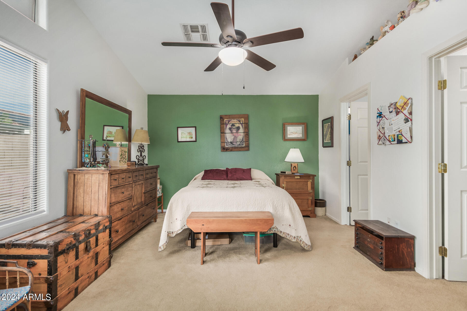 9124 West Calavar Road Peoria, AZ 85381 - Photo 4 of 25 a bed room with a bed and a chandelier