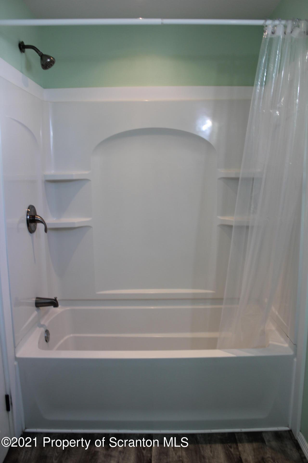518 Spring Street Moosic, PA 18507 - Photo 4 of 26 a bathroom with a bathtub and a shower