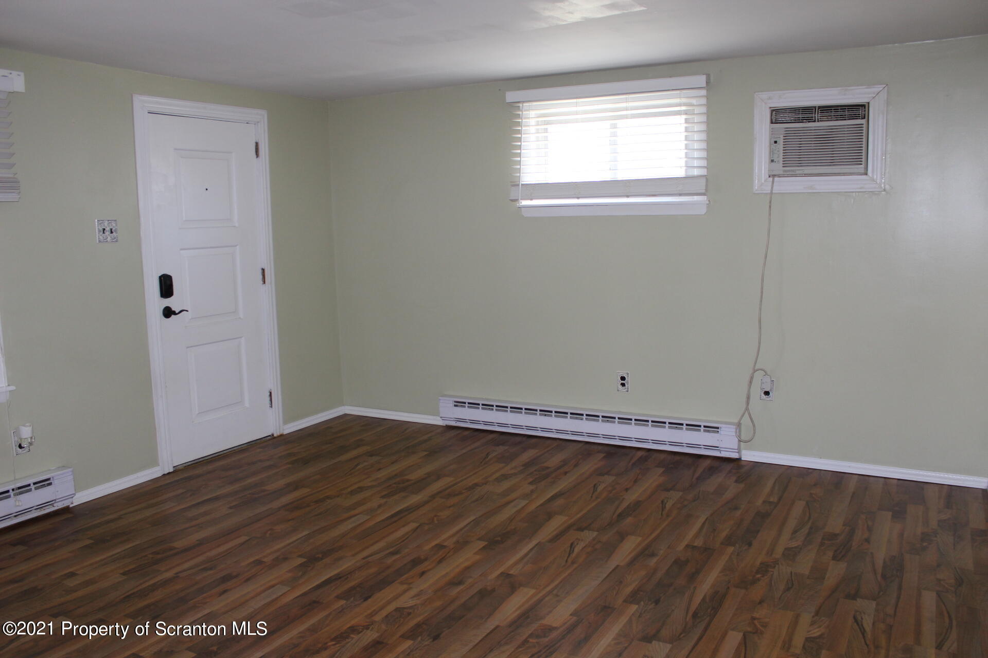 518 Spring Street Moosic, PA 18507 - Photo 6 of 26 a view of an empty room with wooden floor and a window
