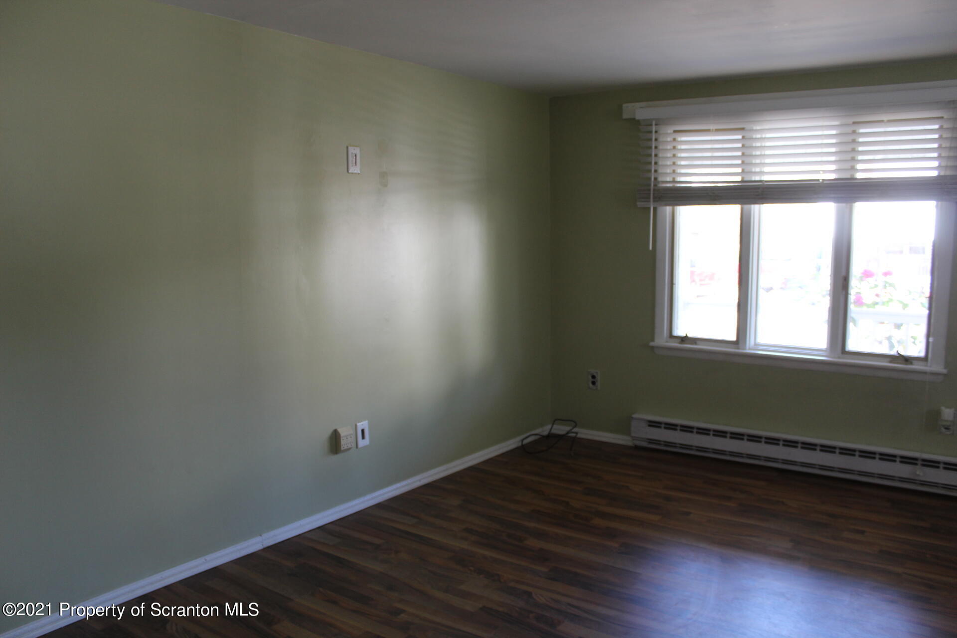 518 Spring Street Moosic, PA 18507 - Photo 7 of 26 an empty room with wooden floor and windows