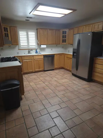 a kitchen with stainless steel appliances a stove a sink and a refrigerator