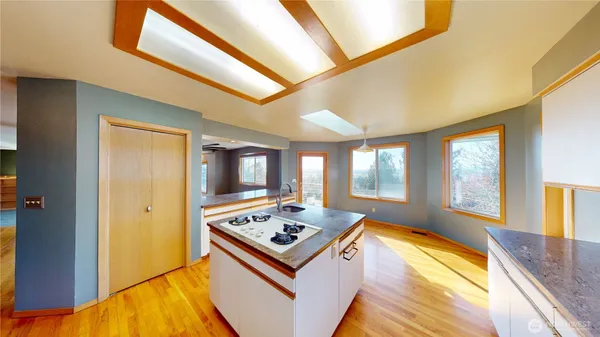 a living room with stainless steel appliances furniture stove and a kitchen view