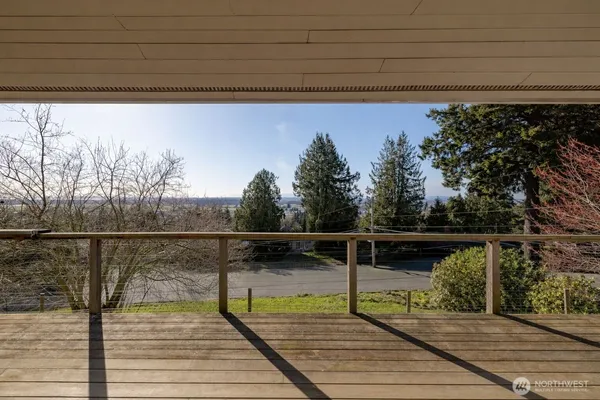 a view of outdoor space with wooden deck and lake