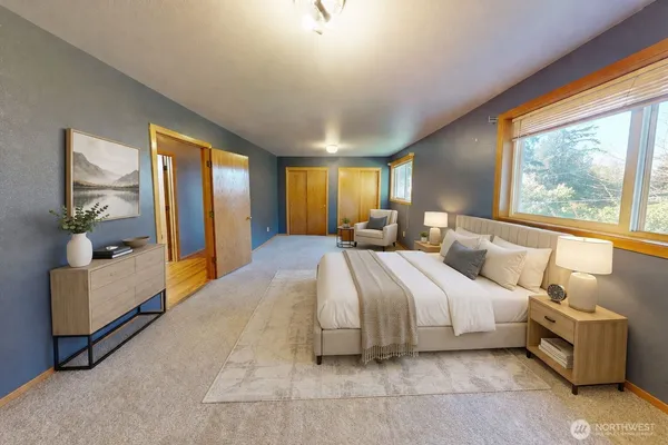 a spacious bedroom with a large bed and a large window