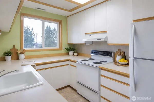 a kitchen with a sink and a stove top oven