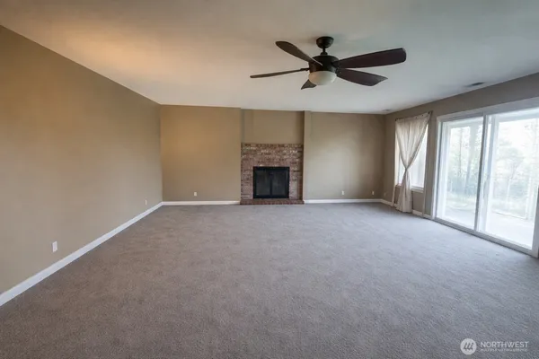 a view of a livingroom with a ceiling fan and window