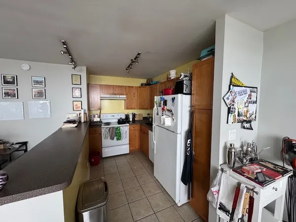 a kitchen with refrigerator a stove and cabinets