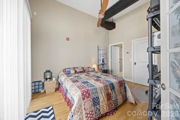 a bedroom with a bed and a chandelier