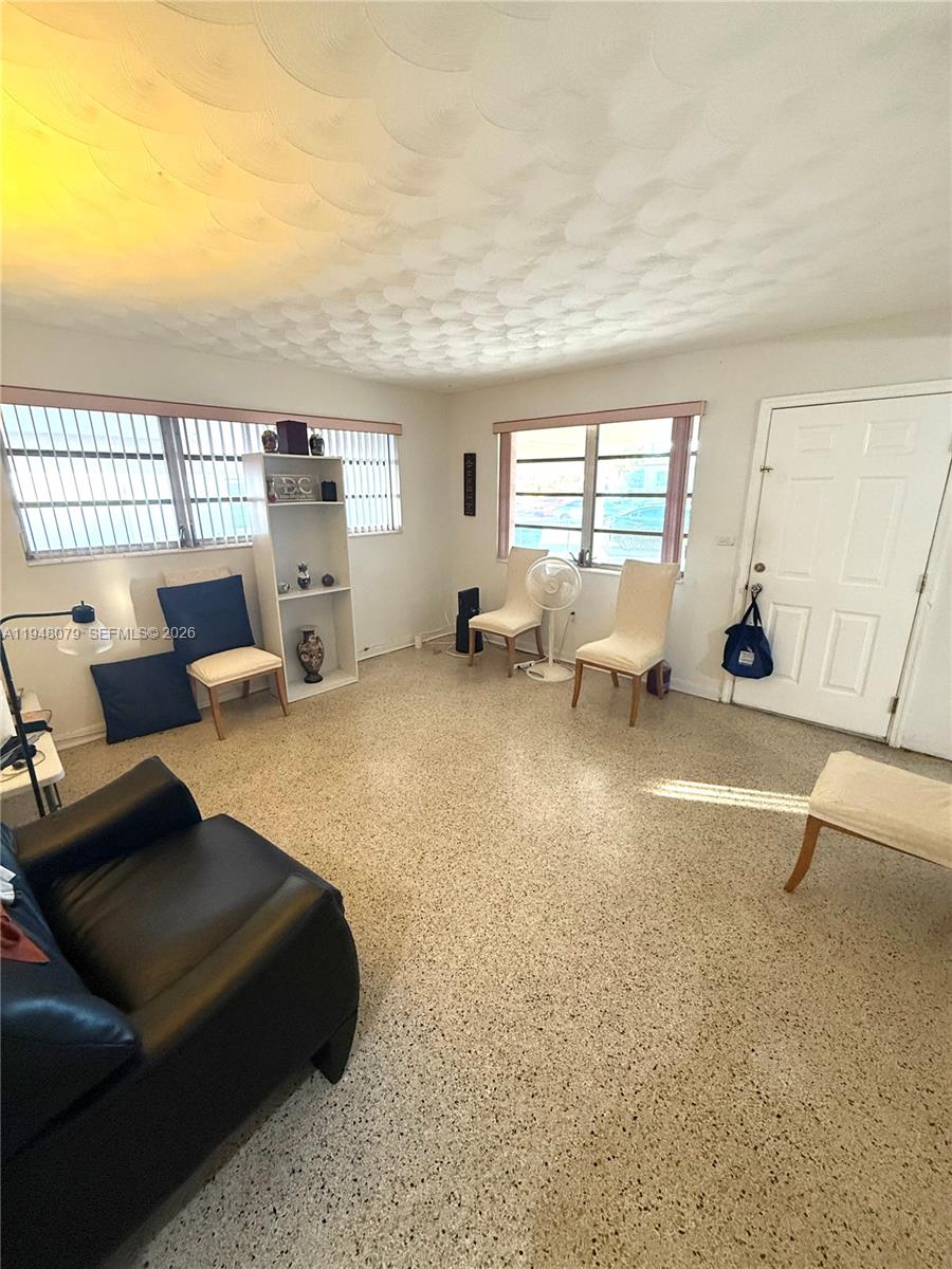 5181 Northwest 5th Street Miami, FL 33126 - Photo 2 of 8 a living room with furniture and a large window