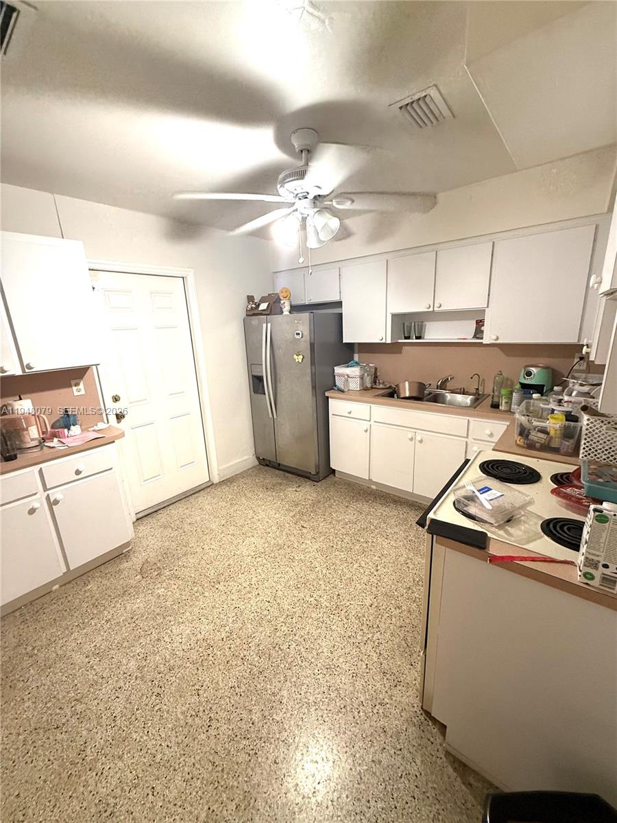 5181 Northwest 5th Street Miami, FL 33126 - Photo 4 of 8 a kitchen that has a stove and a refrigerator
