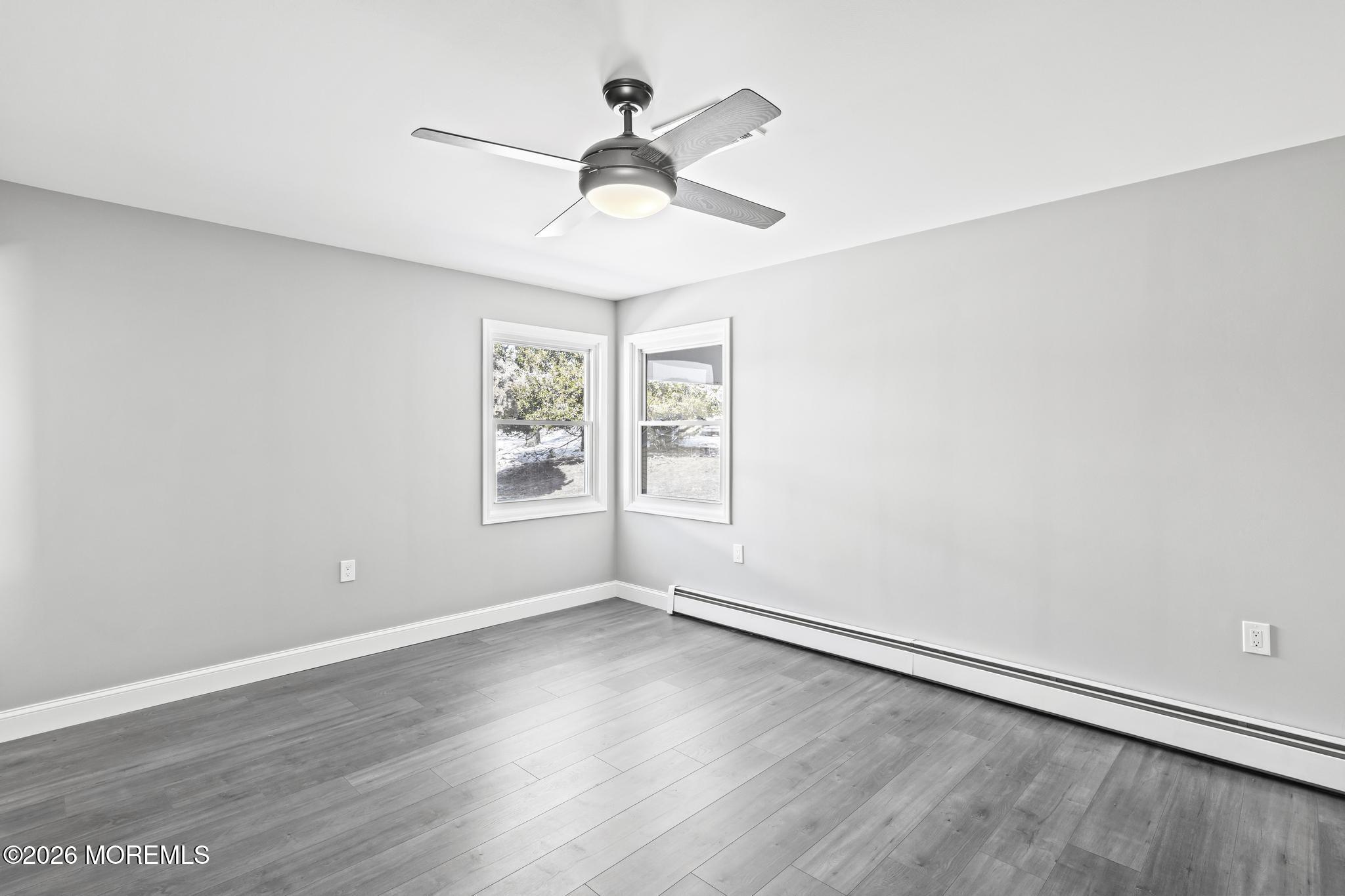 3 Muirhead Street Toms River, NJ 08757 - Photo 21 of 34 an empty room with wooden floor ceiling fan and windows
