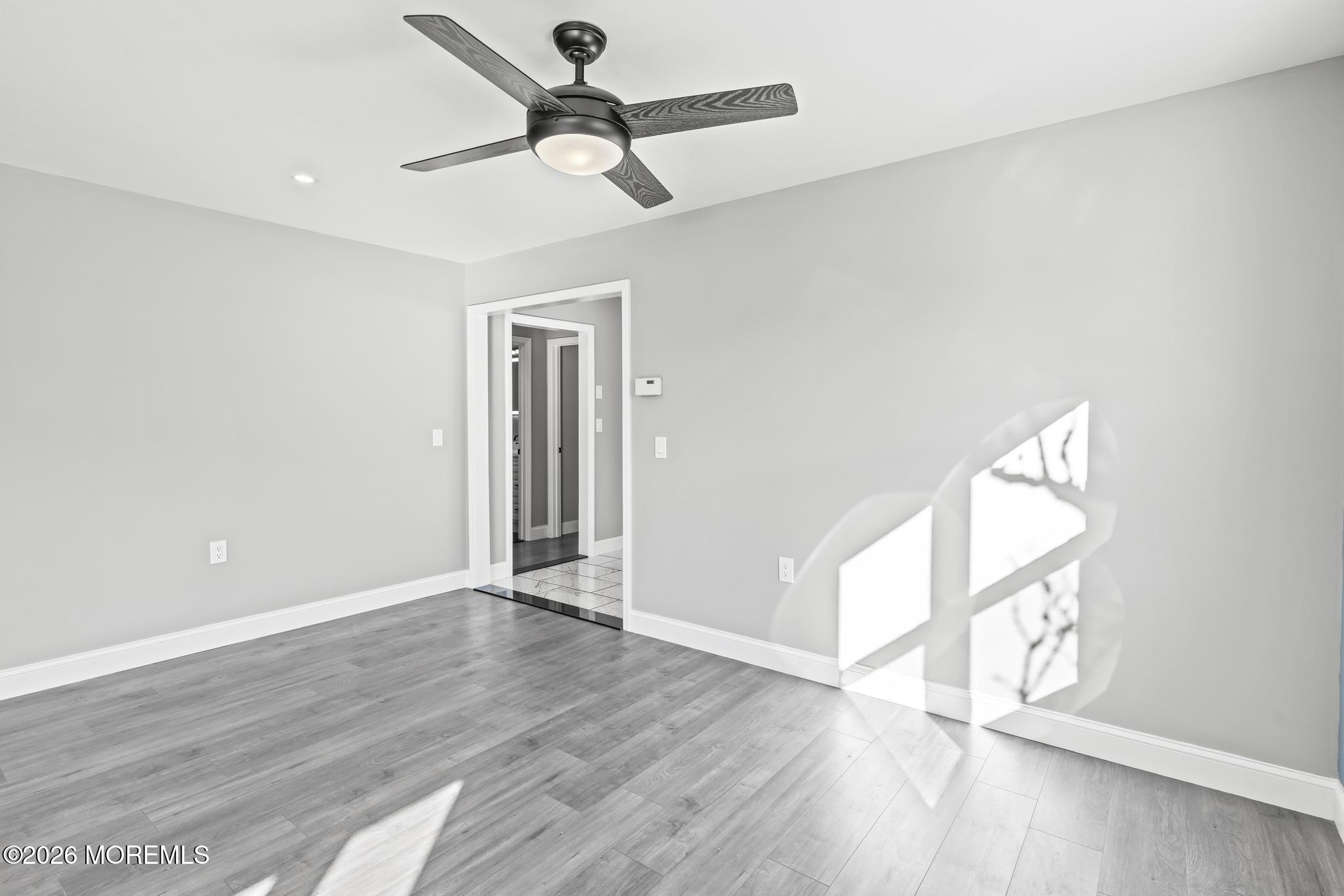 3 Muirhead Street Toms River, NJ 08757 - Photo 24 of 34 an empty room with wooden floor fan and windows