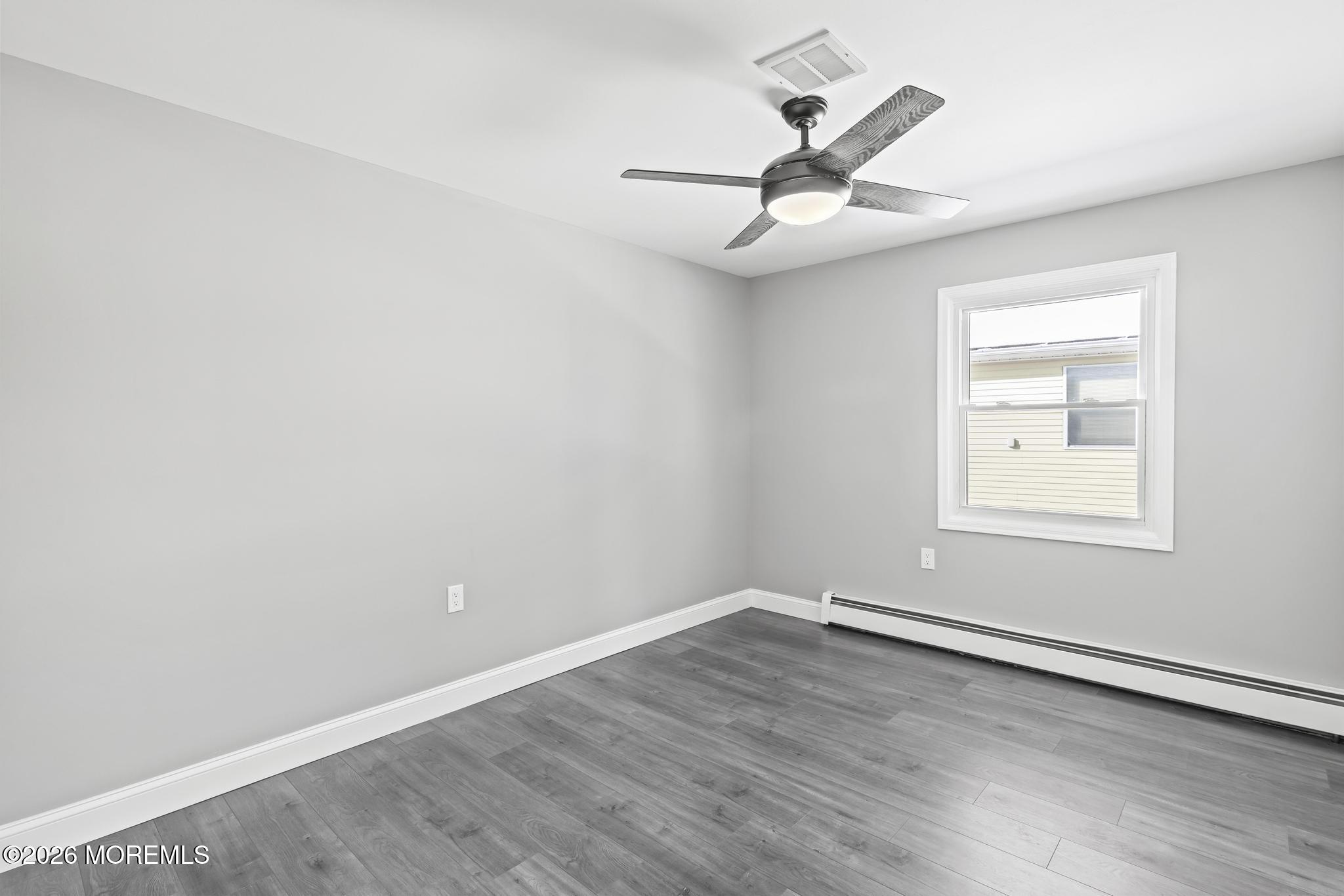 3 Muirhead Street Toms River, NJ 08757 - Photo 27 of 34 an empty room with wooden floor ceiling fan and windows