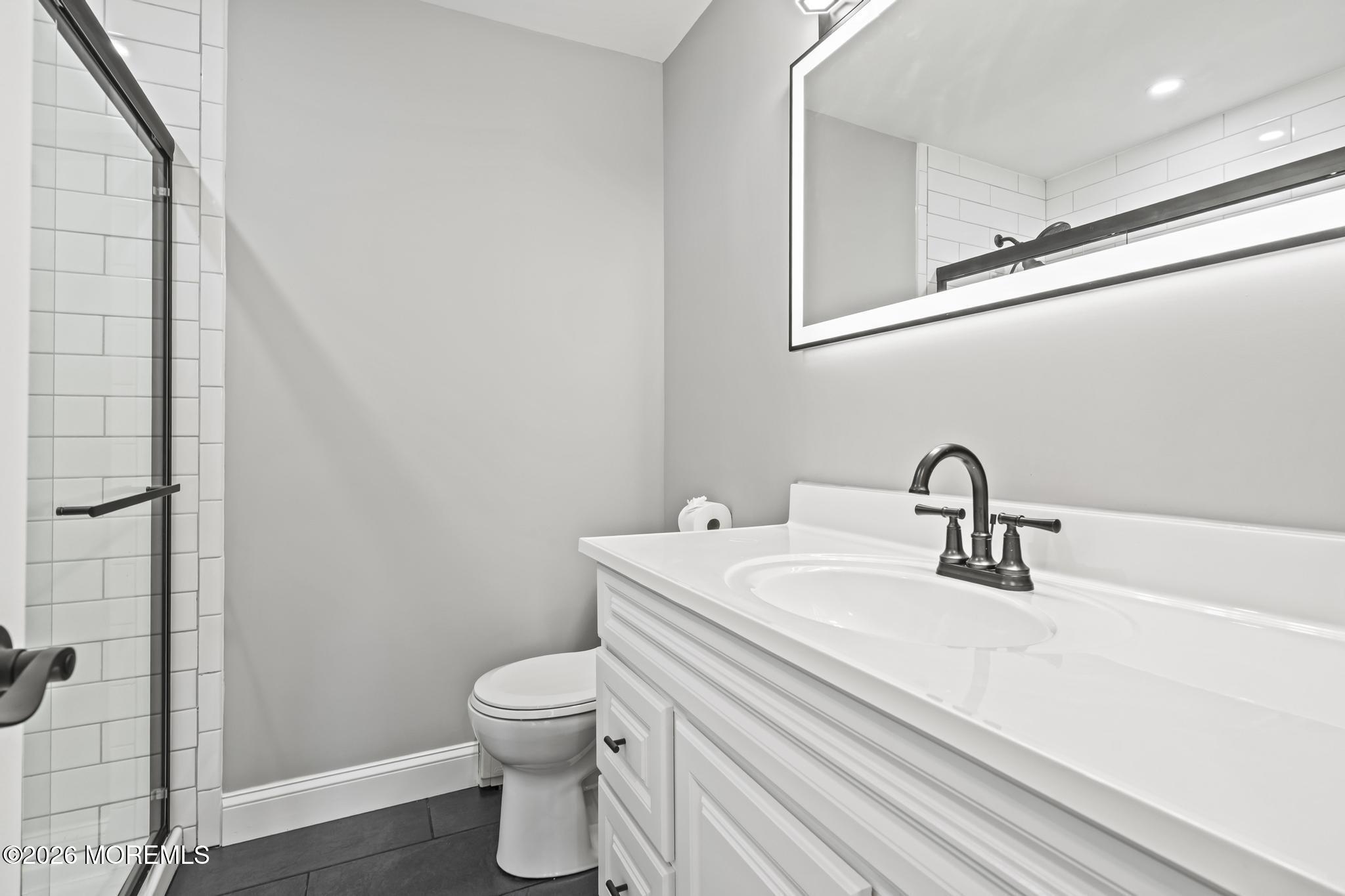 3 Muirhead Street Toms River, NJ 08757 - Photo 28 of 34 a bathroom with a toilet a sink and mirror
