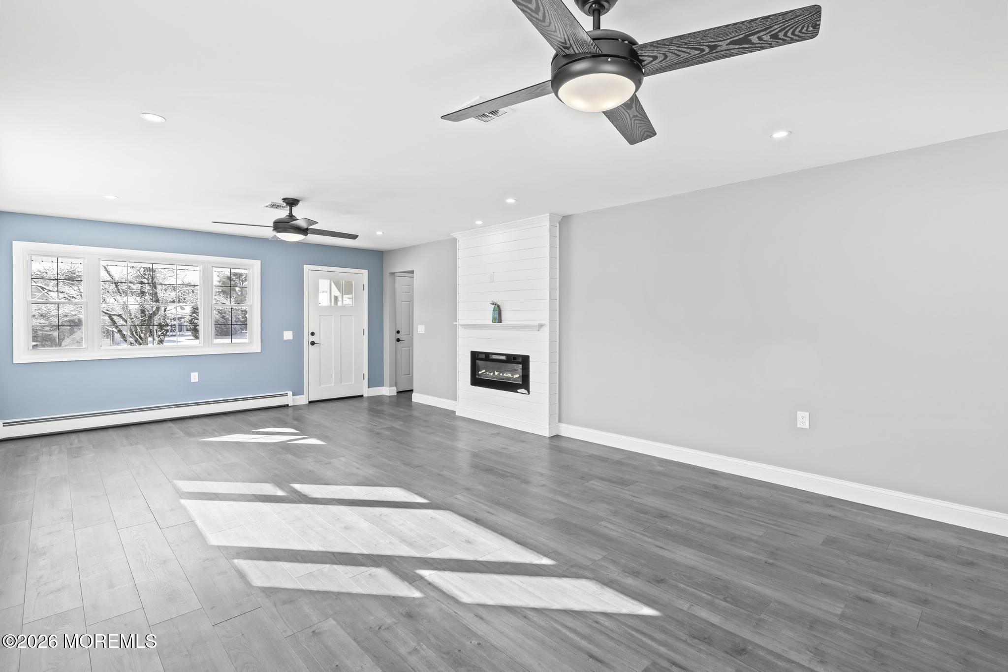 3 Muirhead Street Toms River, NJ 08757 - Photo 9 of 34 an empty room with wooden floor ceiling fan and windows