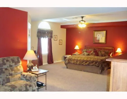 a living room with furniture a lamp and a chandelier