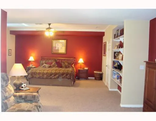 a bedroom with a bed and lamp