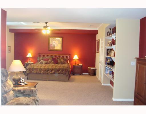 307 Calley Springs Street Portland, TX 78374 - Photo 6 of 10 a bedroom with a bed and lamp