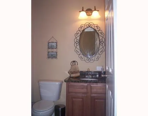 a bathroom with a toilet a sink and a mirror