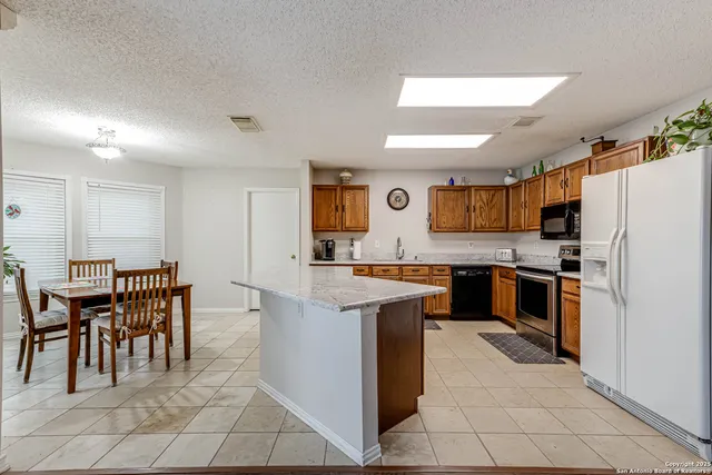 a kitchen with cabinets and chairs